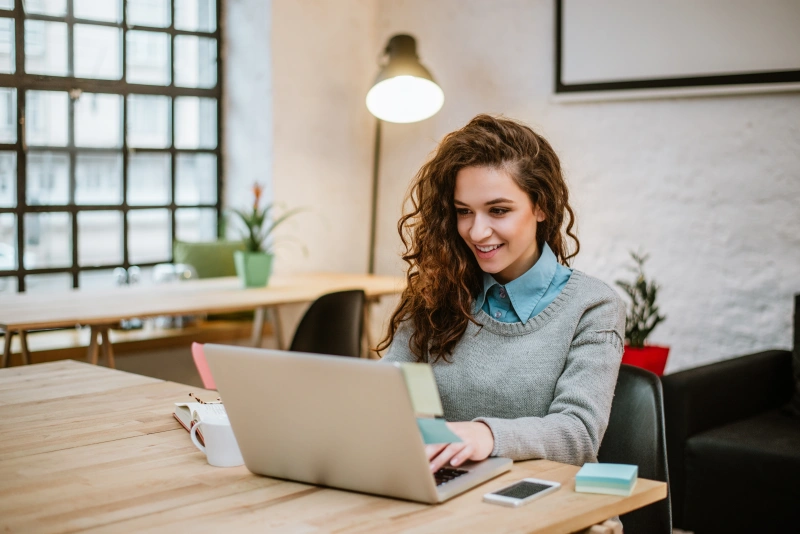 Successful young woman modern office working laptop